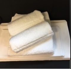 Folded white towels on tray