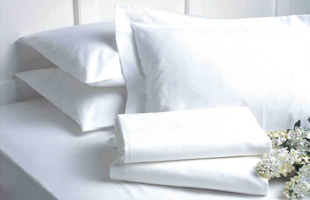 Clean white bed linen with flowers